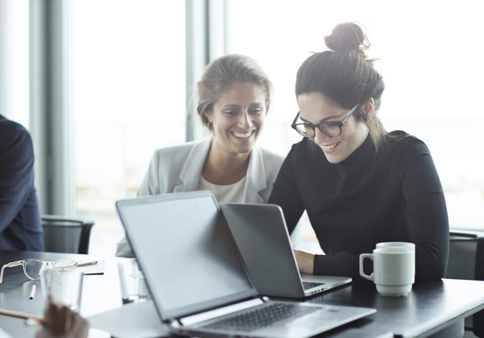 Business people in large modern meeting room