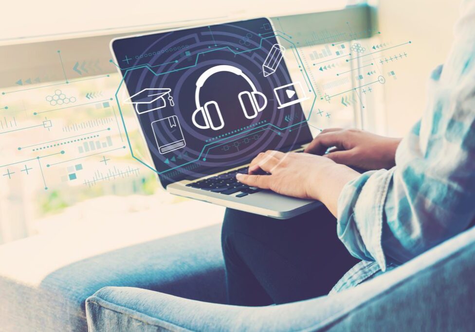 E-learning concept with woman using her laptop in her home office